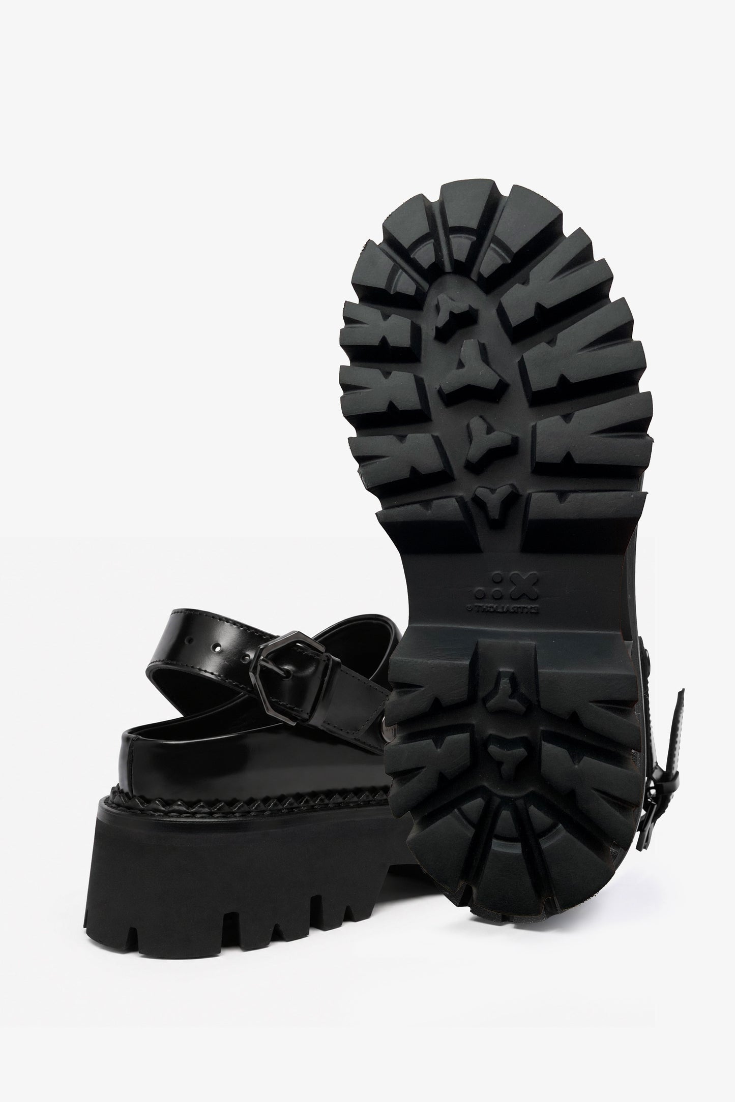 Berry black leather mule, front view with one shoe upright showing the outsole