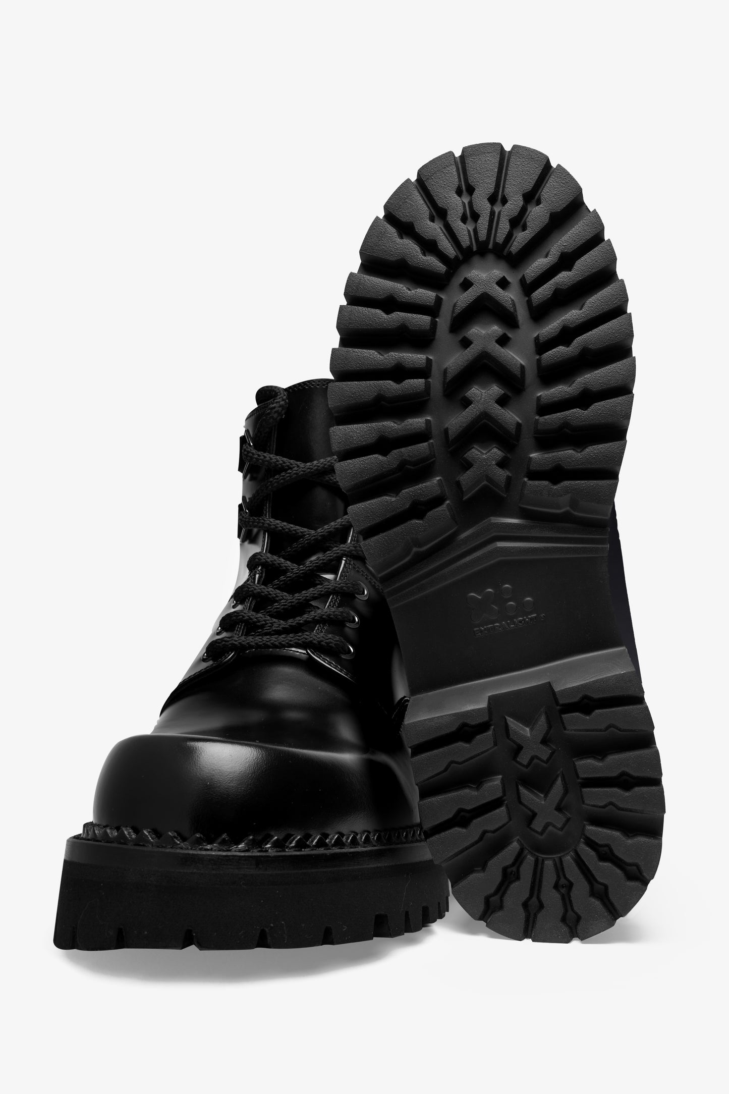 Pair of Smith black leather combat boots, front view with one boot upright showing the outsole