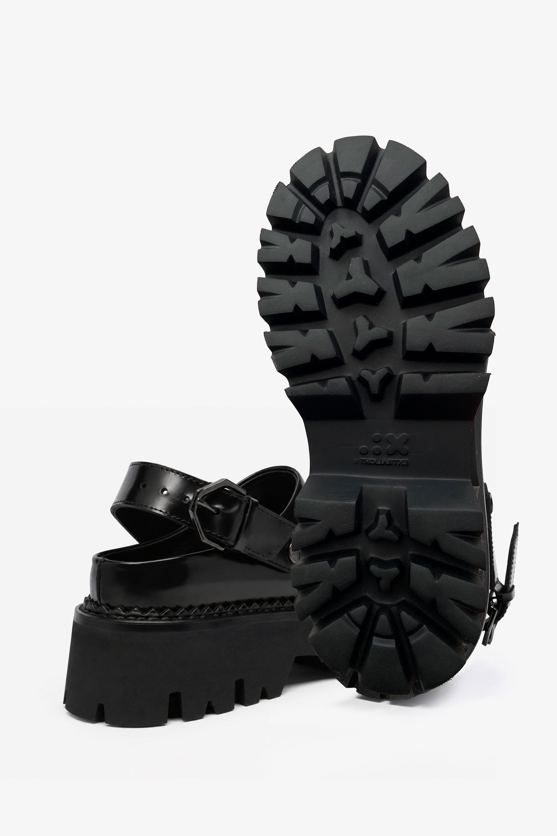 Berry black leather mule, front view with one shoe upright showing the outsole