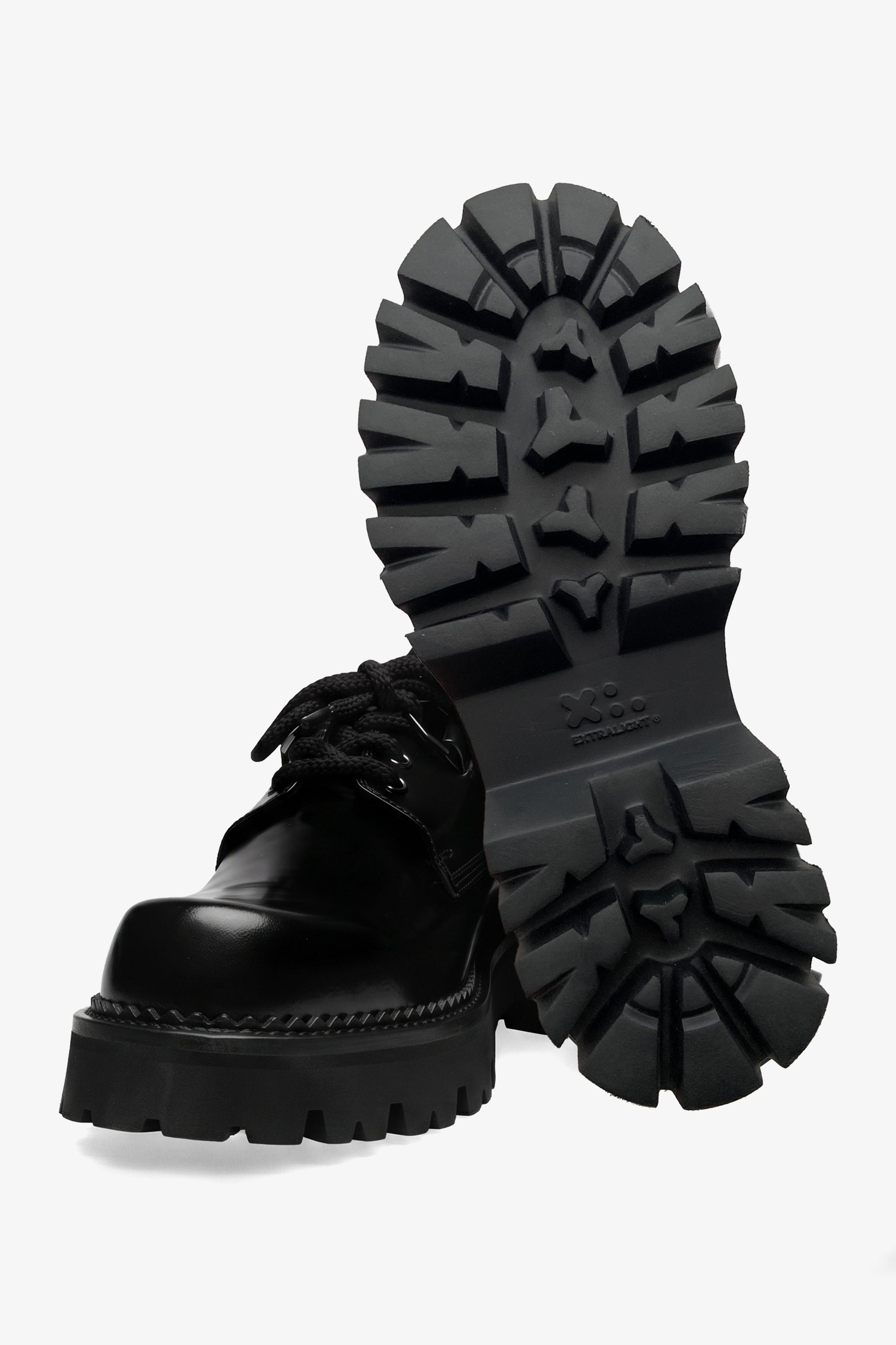 Curtis woman black leather derby shoe, front view with one shoe upright showing the outsole